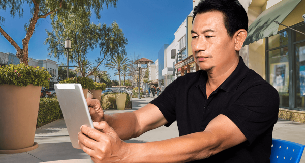 mature man holding a tablet