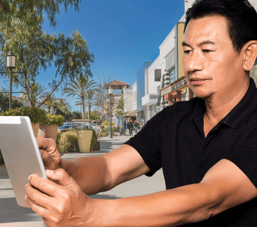 mature man holding a tablet